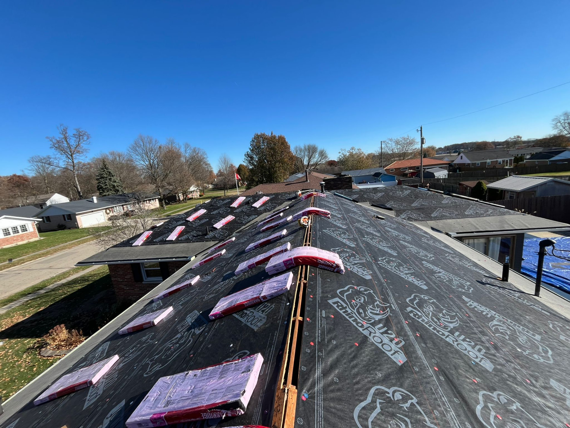 Tear-off complete with synthetic underlayment and shingle bundles staged